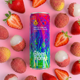 A colorful can of Green Monkey hemp THC-infused soda centered on a pink background with strawberries and lychees