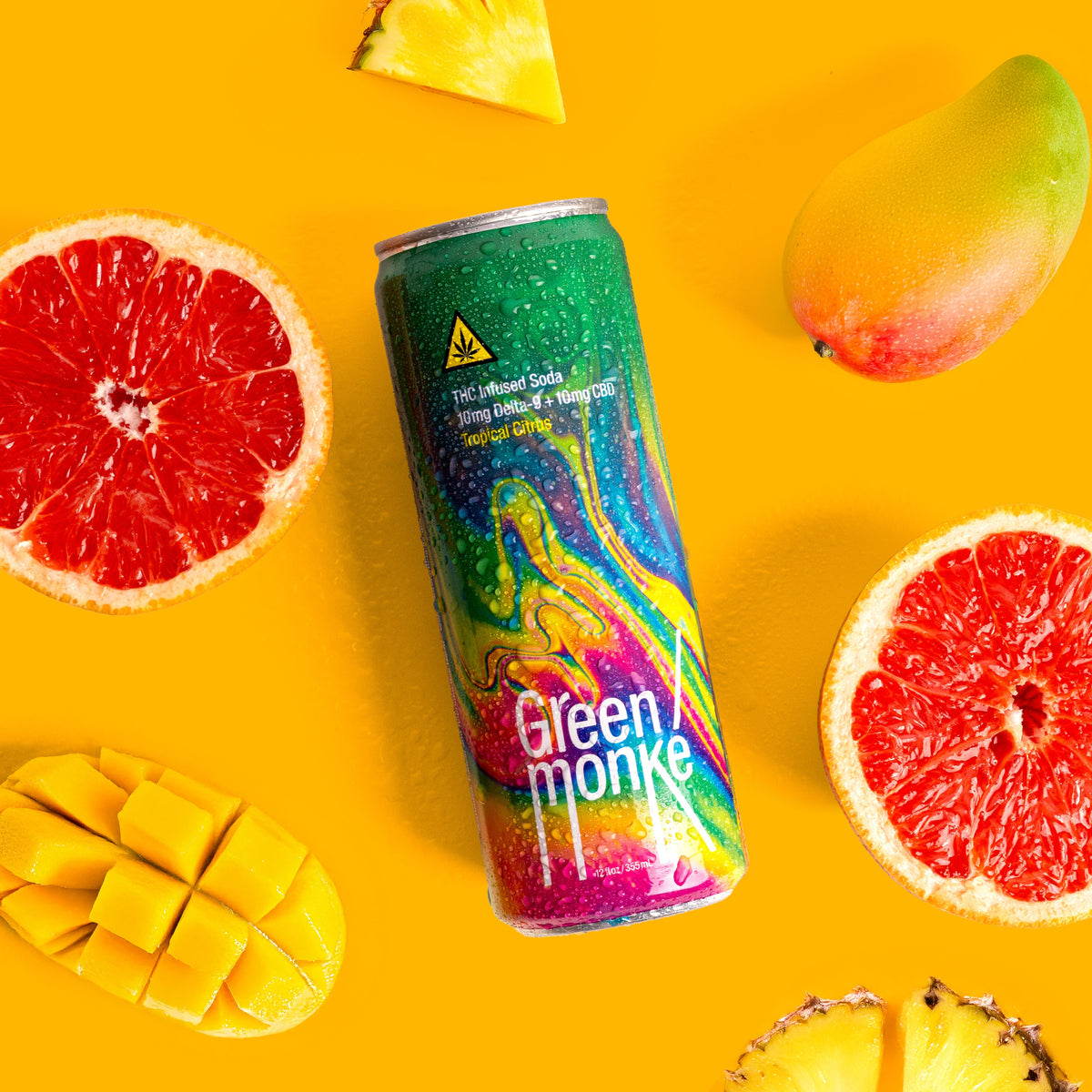 Green Monké Tropical Citrus THC soda can with fresh pineapple, grapefruit and orange